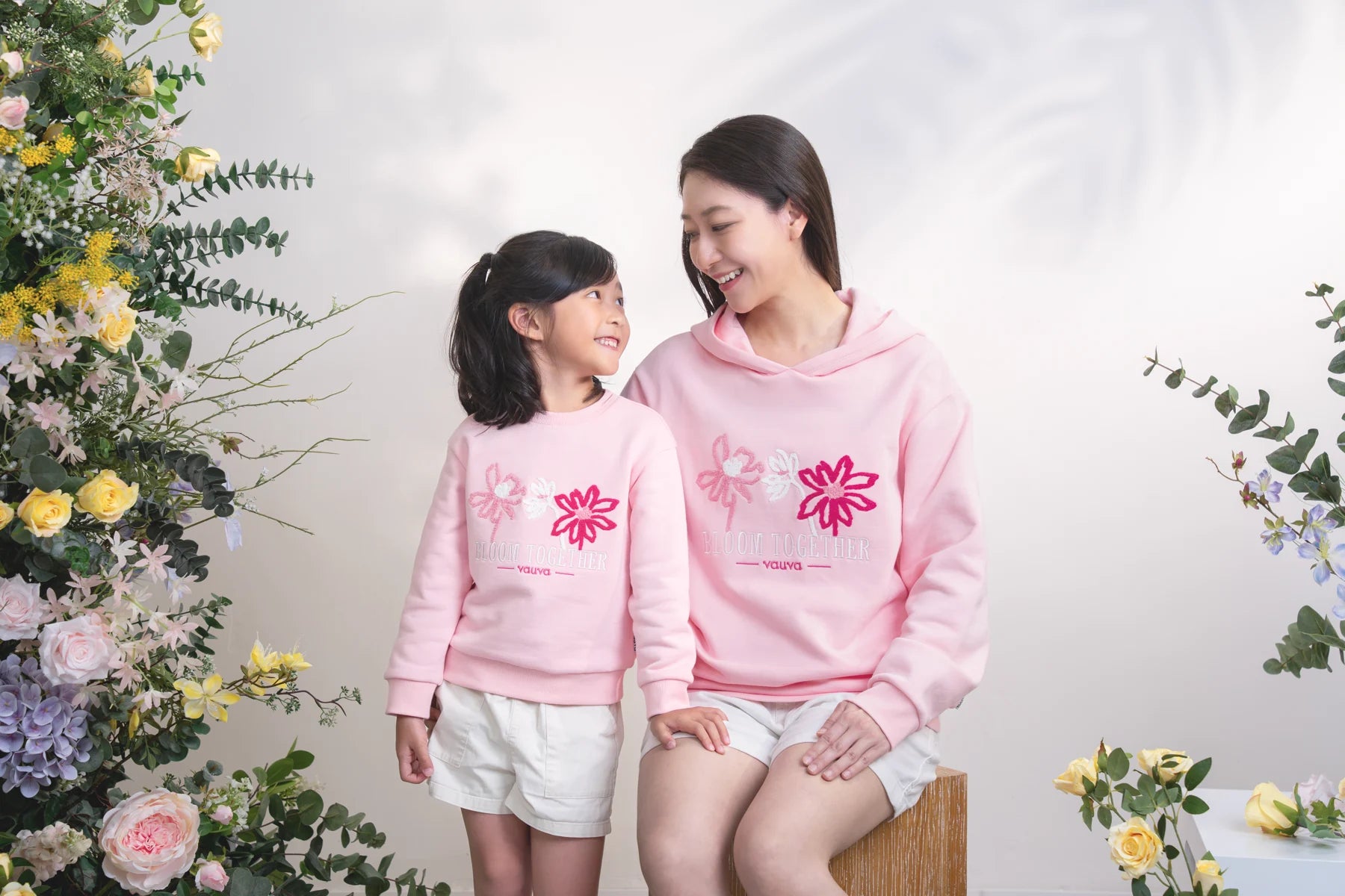 Mother and child wearing coordinating pink Lydia hoodie and sweatshirt.
