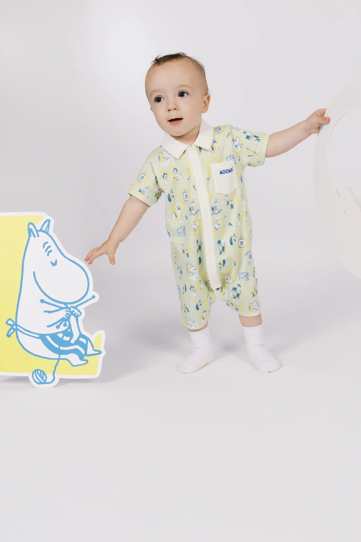 Baby wearing the seafoam Moomin print romper from Spring Summer 2026.
