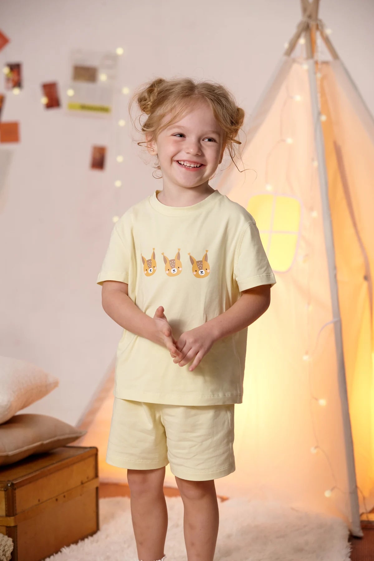 A child in the yellow squirrel T-shirt and matching shorts.