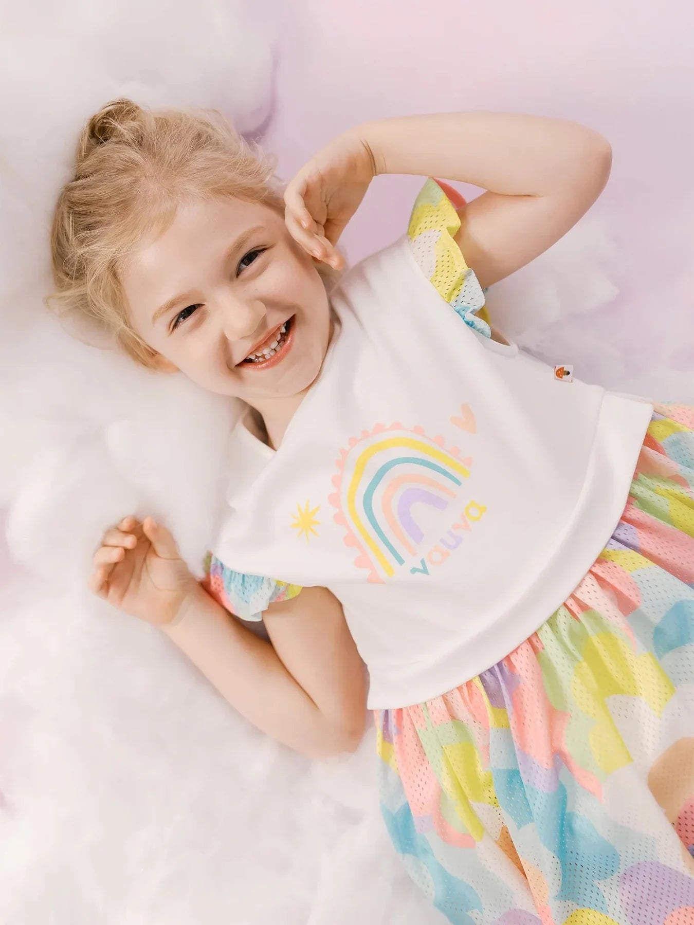 Girl in the rainbow graphic flare dress with a multicolour floral skirt.
