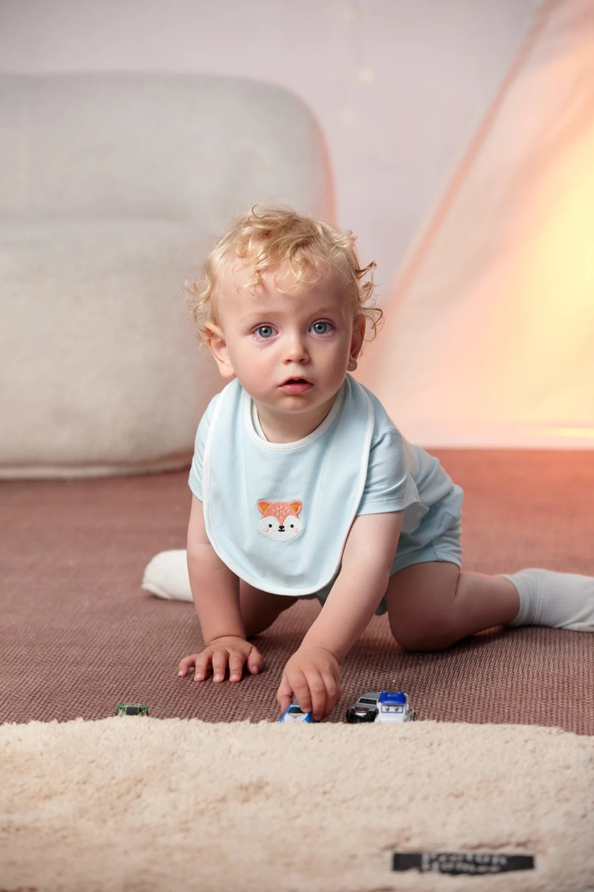 Baby wearing the solid mint fox bib from the Fox Essentials gift set.