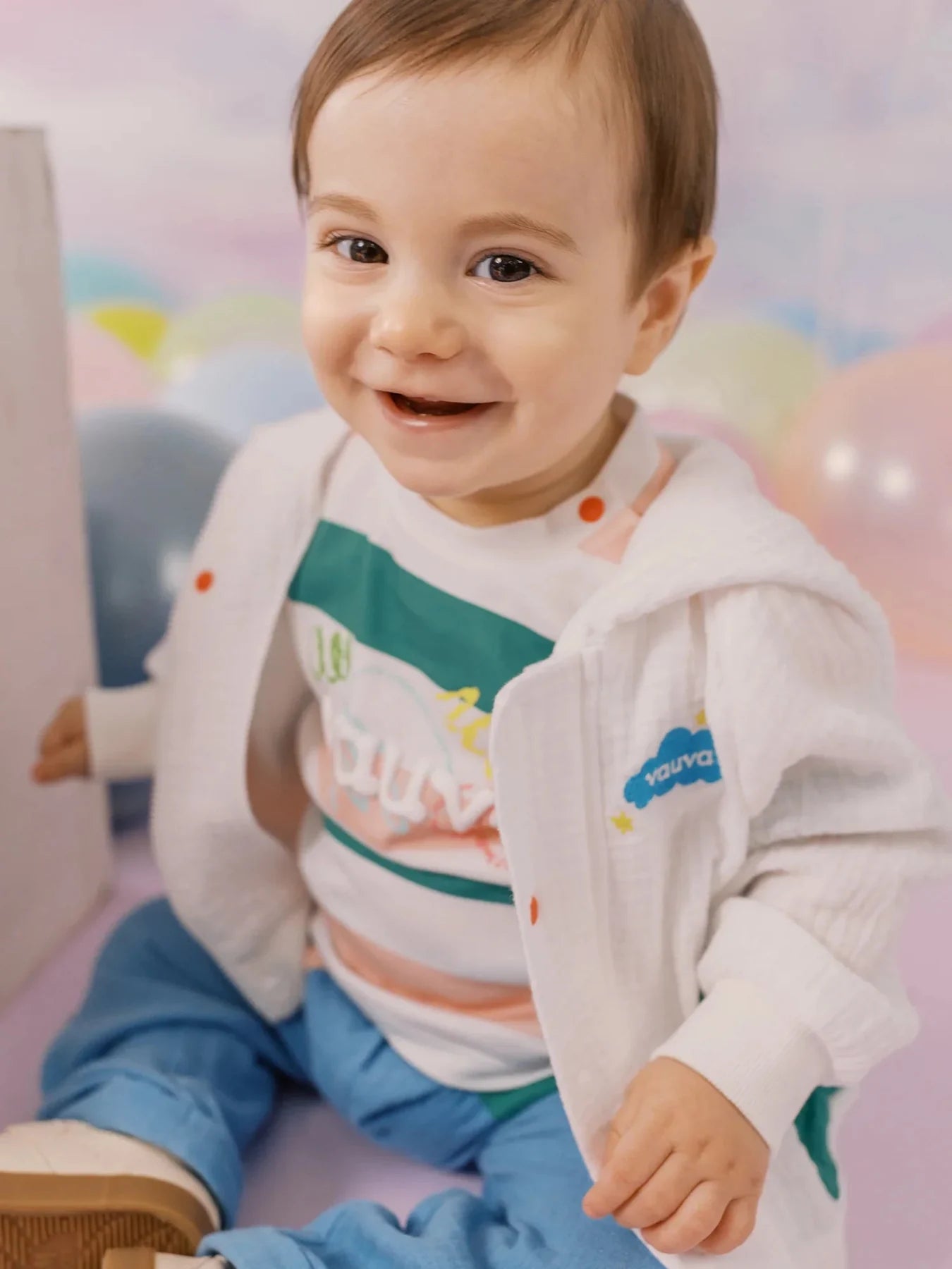 Baby wearing a green striped Vauva tee.