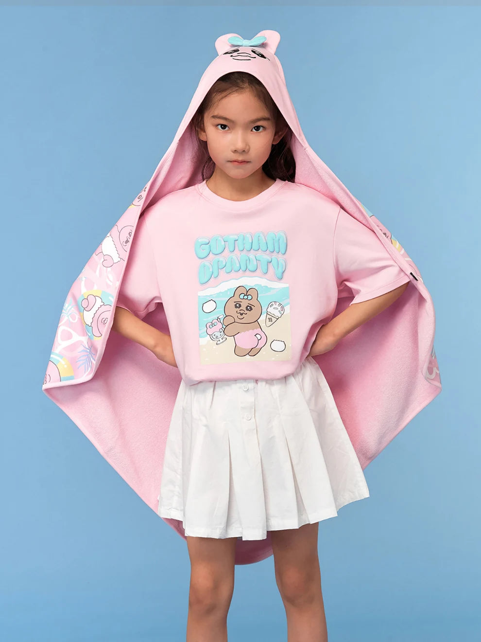 The pink character blanket wraps around the pink Summer Day tee.