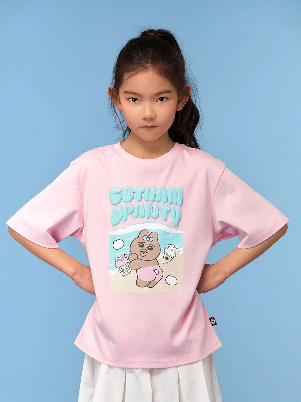 A pink graphic tee carries an expressive Opanchu seaside scene.