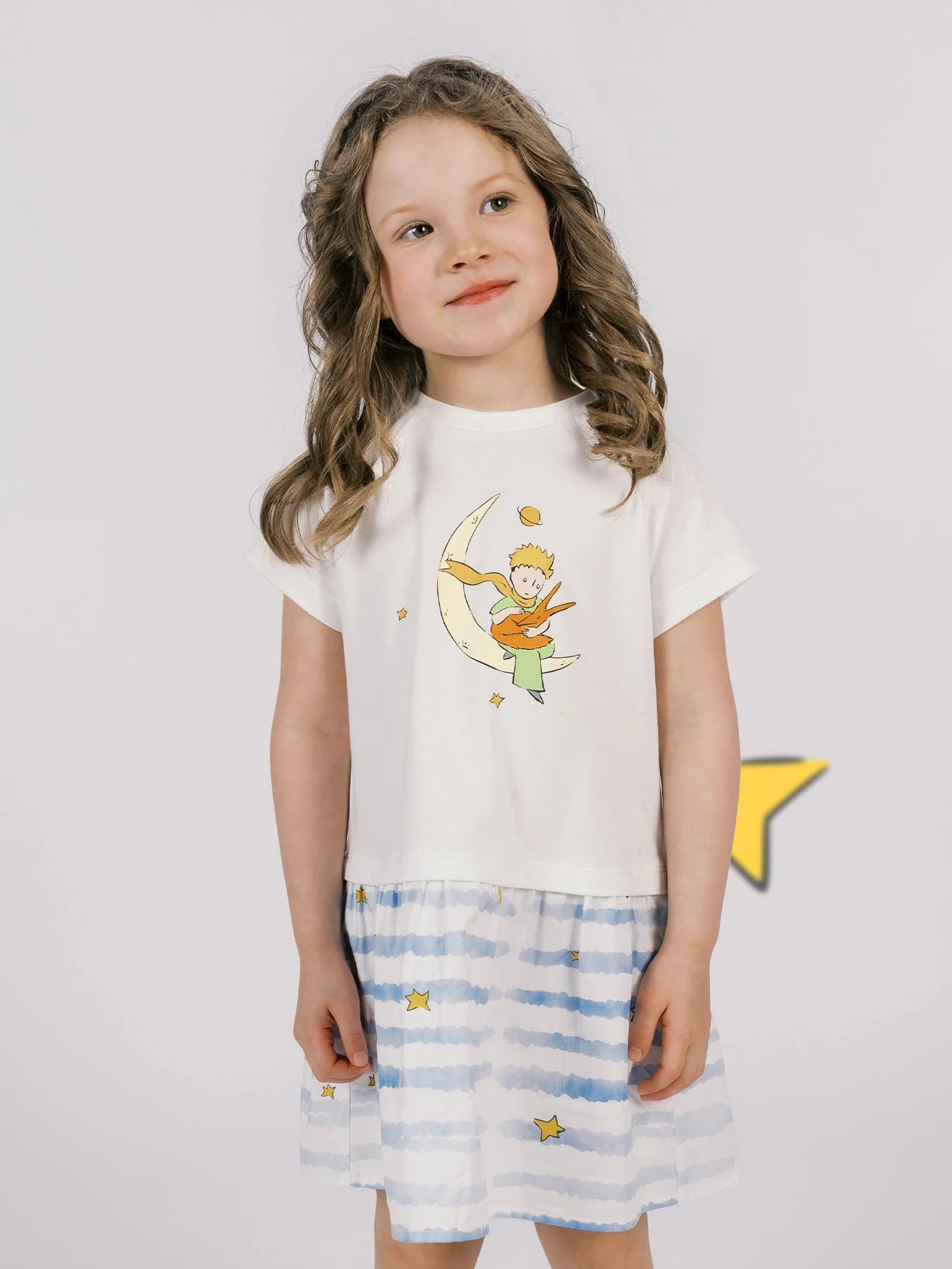 The Little Prince and fox artwork sits above a blue-striped skirt in this two-tone dress.