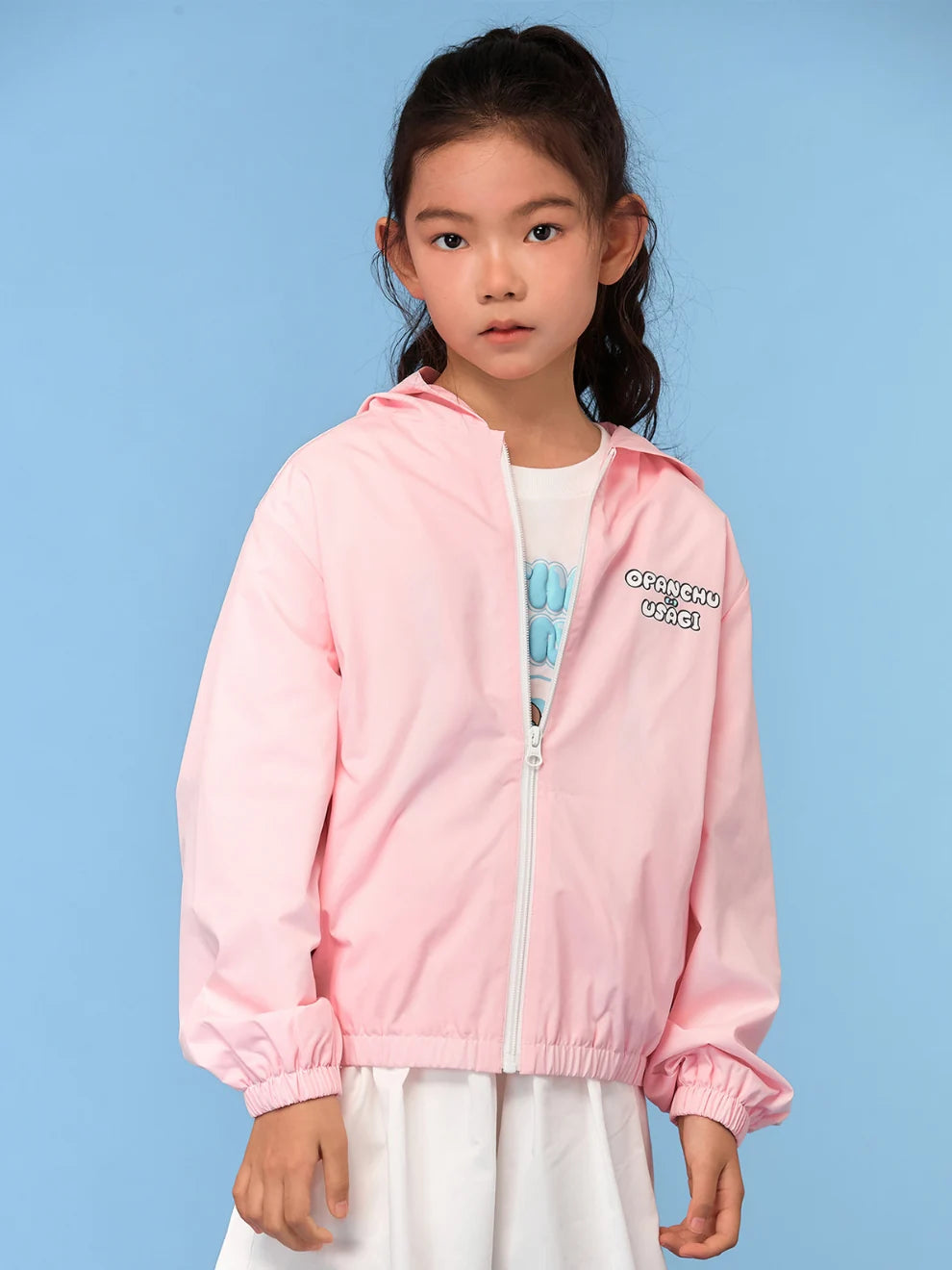 The pink printed jacket layers over a white character tee.
