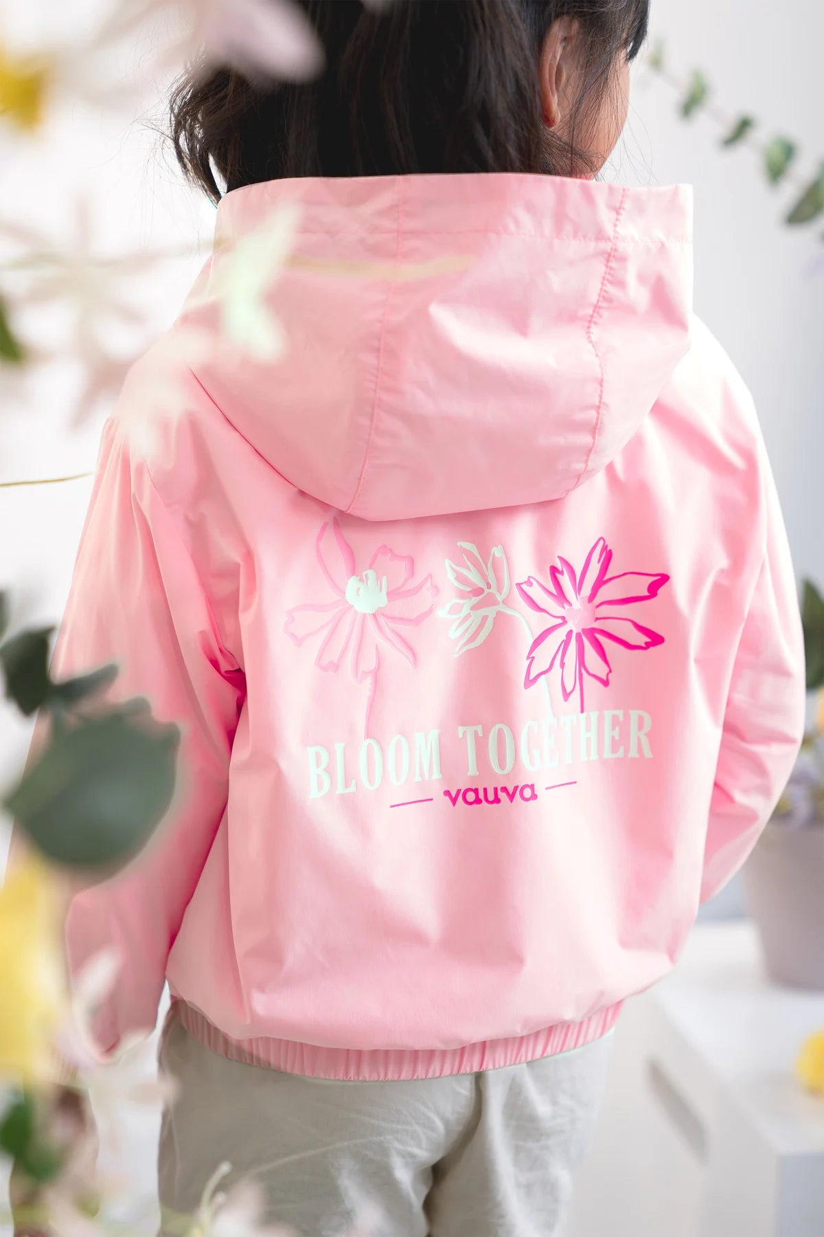 The floral signature on the children’s hooded jacket.