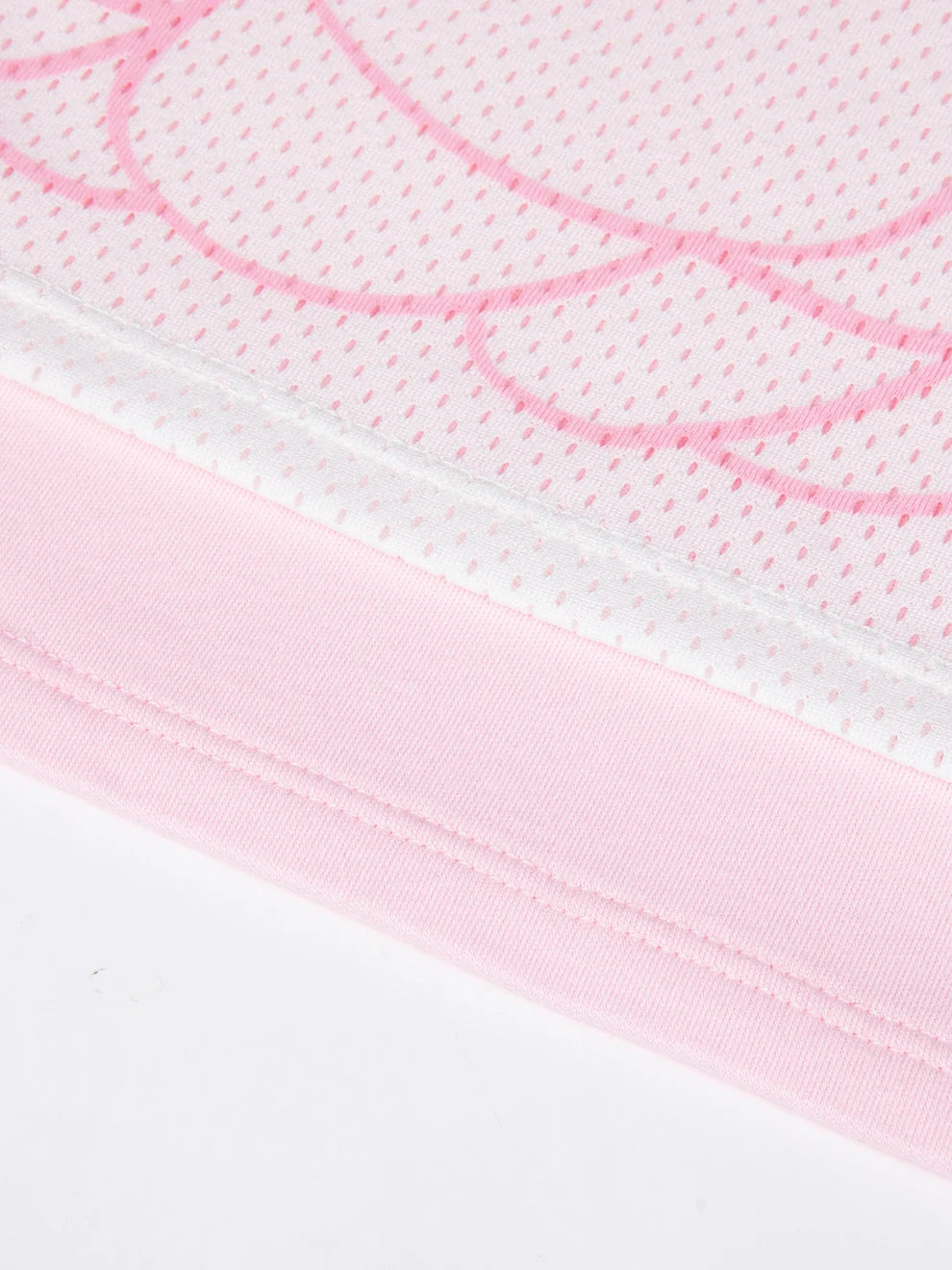 Close view of the all-over Opanchu artwork on the pink printed tee.