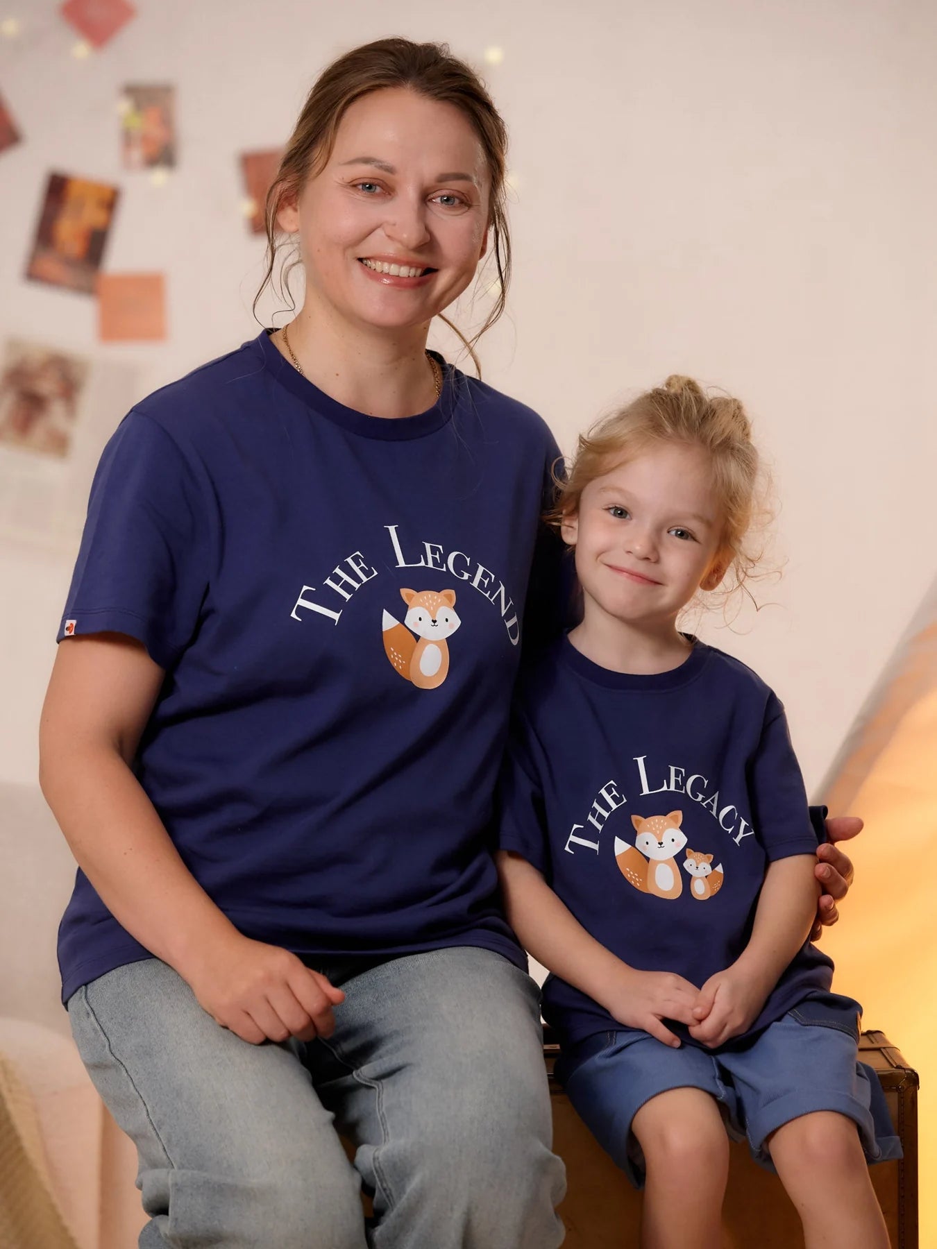 Adult and child in matching navy Legend and Legacy tees.