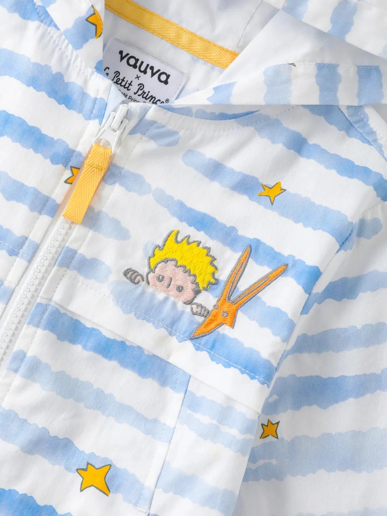 Close view of stars, character embroidery and yellow zip on the striped jacket.