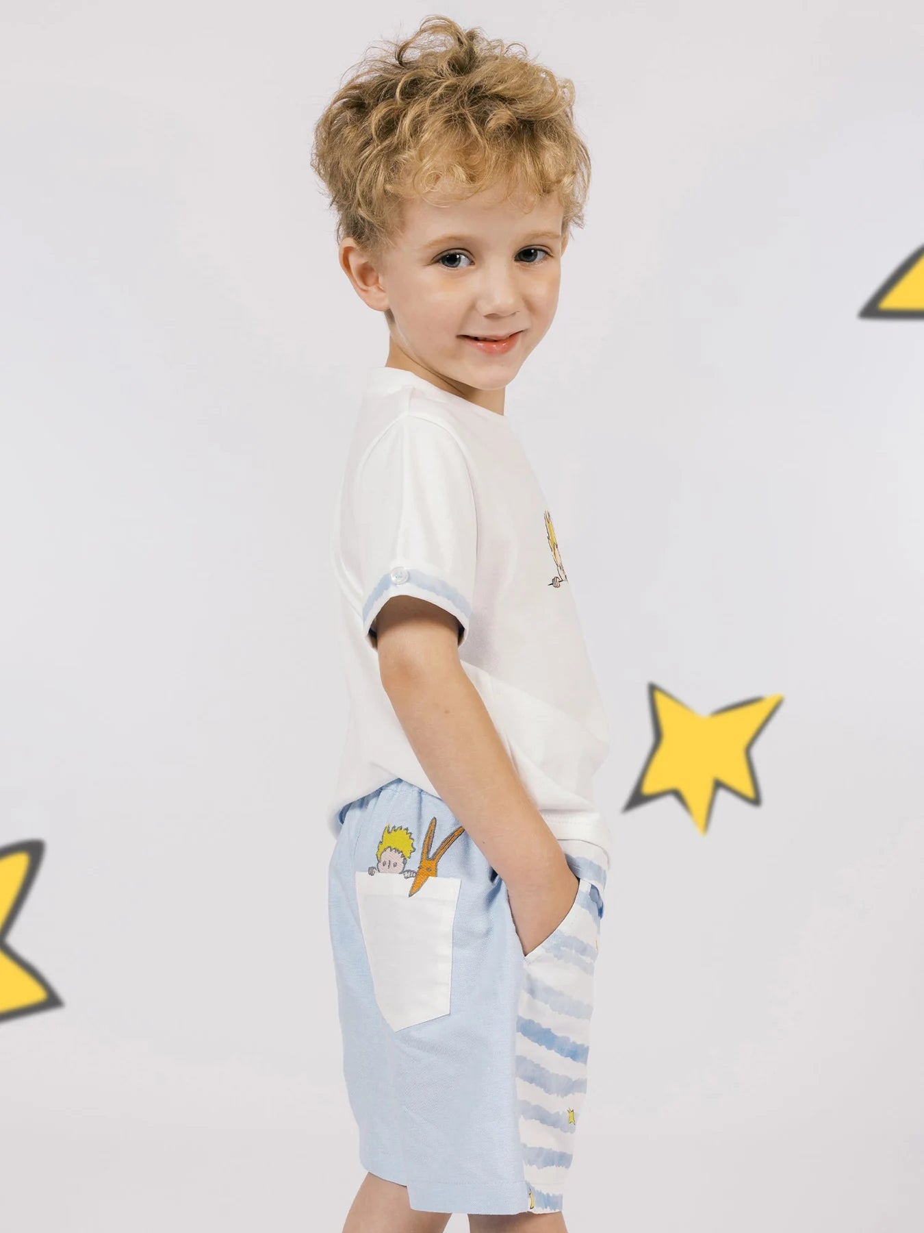 The white two-tone tee pairs with striped Bermuda shorts for a complete collection combination.