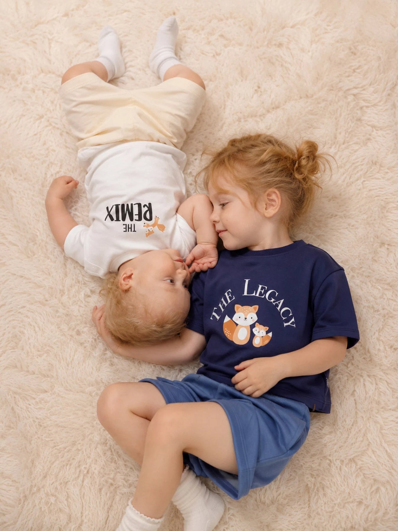 Children wearing The Remix white tee and The Legacy navy tee.