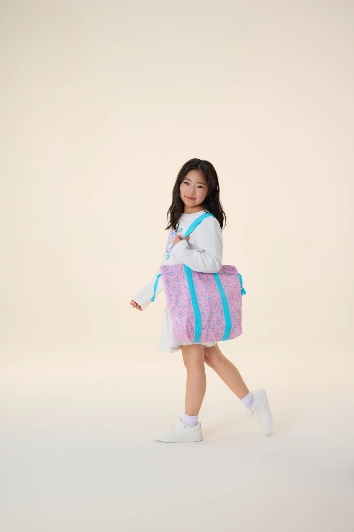 The pink bunny-print tote takes the collection story along.