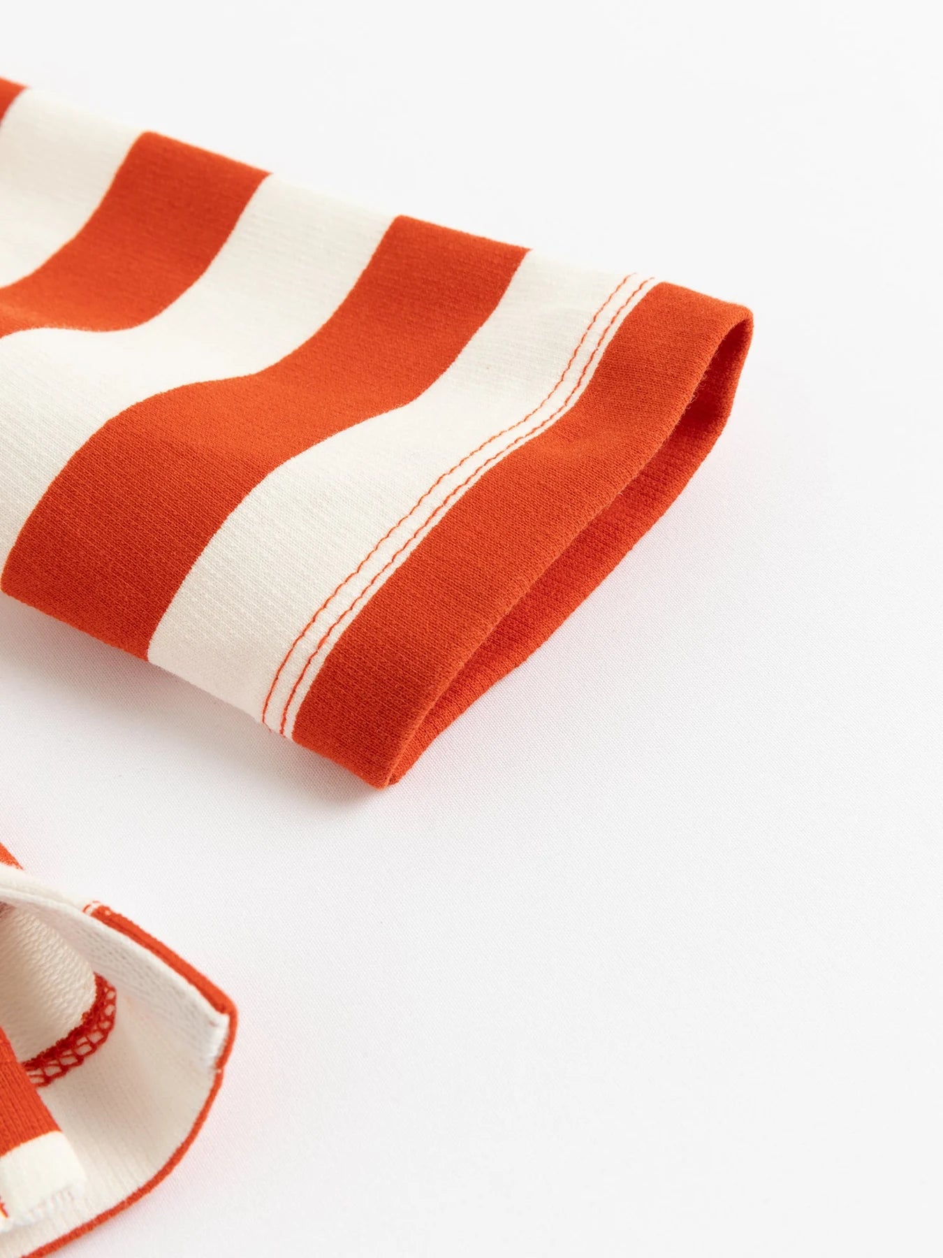 Hedgehog artwork on the red striped tee.