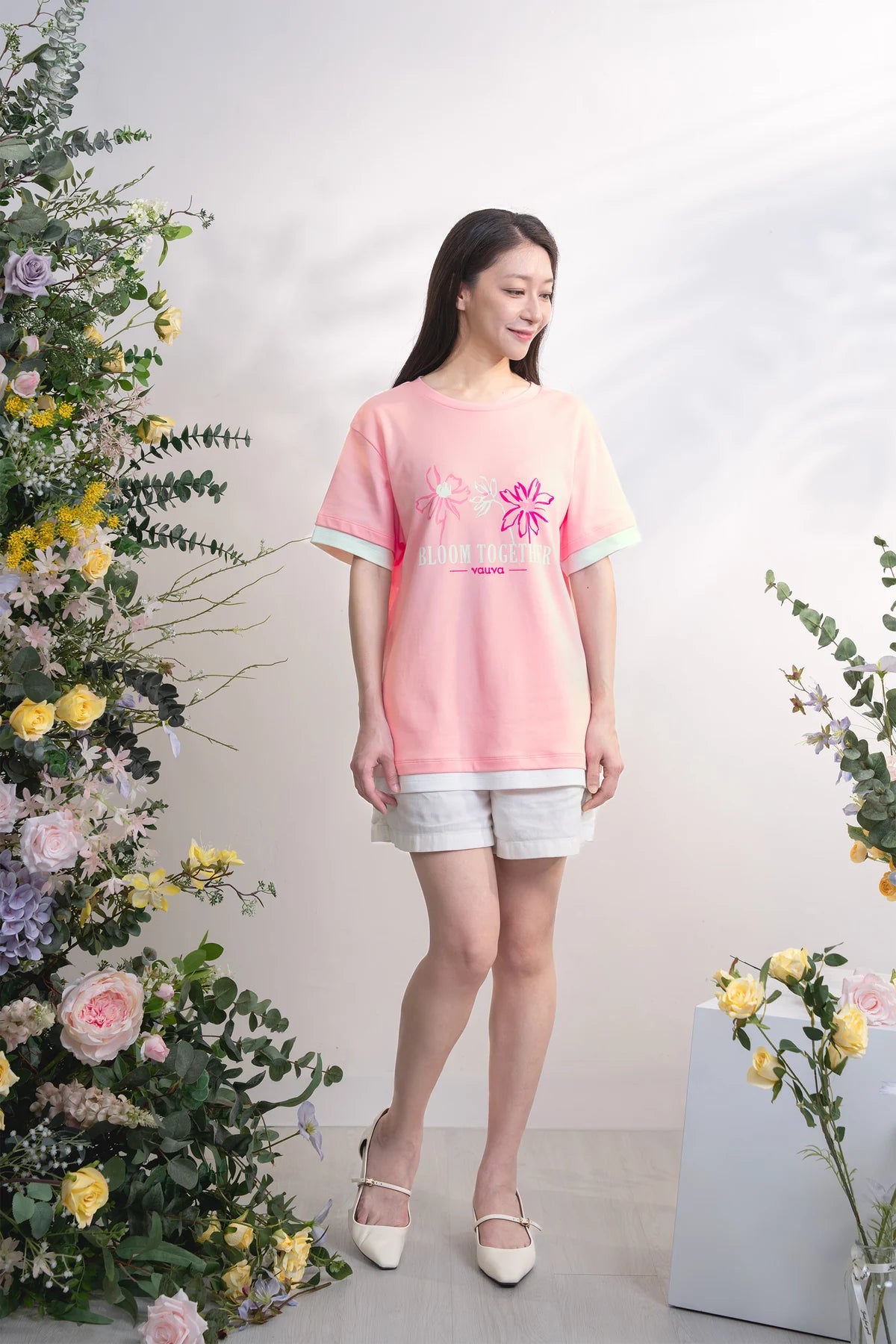 Adult in the pink Bloom Together tee with layered white hems.