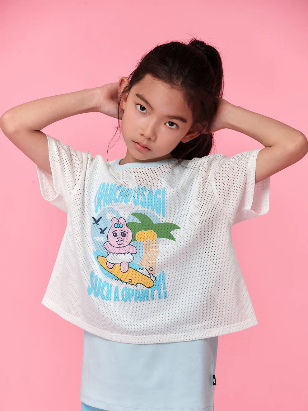 A blue surfing-print tee follows Opanchu into the waves.